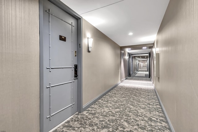 corridor with carpet floors and baseboards