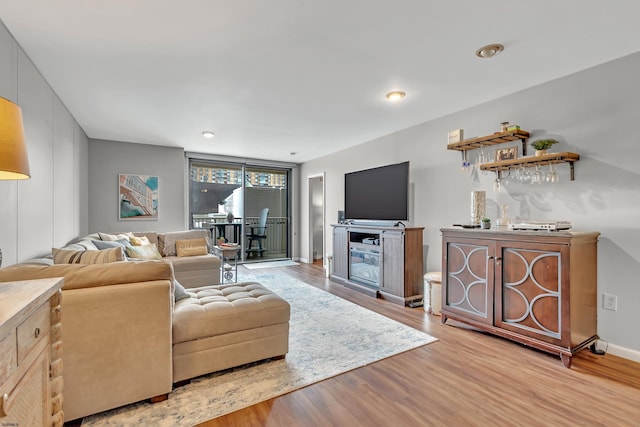 living room featuring light wood-style flooring and baseboards