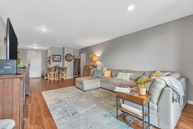 living room with baseboards and wood finished floors