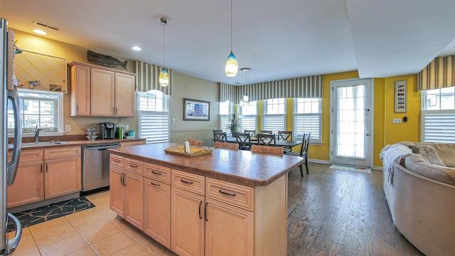 kitchen with dishwasher, open floor plan, dark countertops, and a wealth of natural light