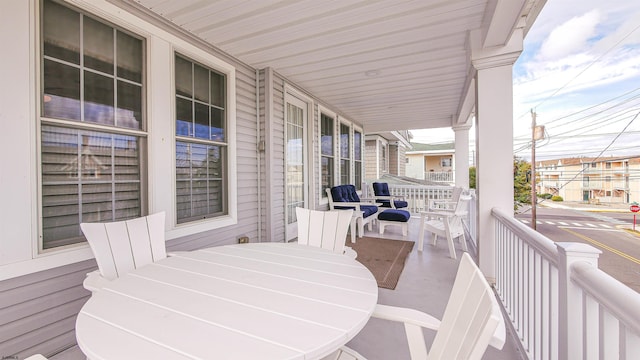 deck featuring a porch and outdoor dining area