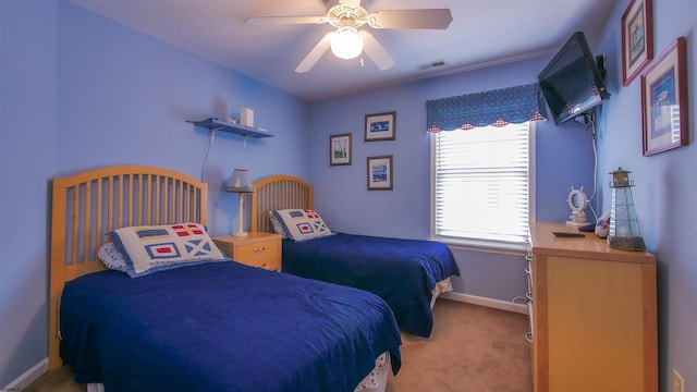 carpeted bedroom featuring visible vents, ceiling fan, and baseboards