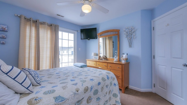 carpeted bedroom featuring visible vents, ceiling fan, and baseboards