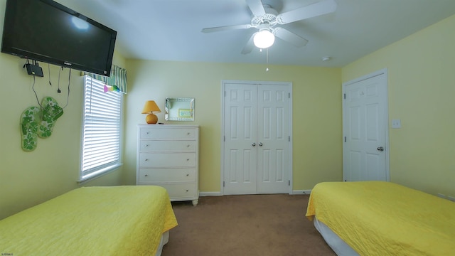 carpeted bedroom with ceiling fan, baseboards, and a closet