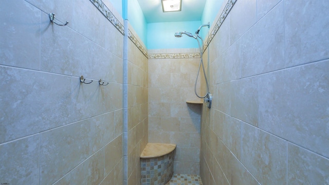 bathroom with a tile shower