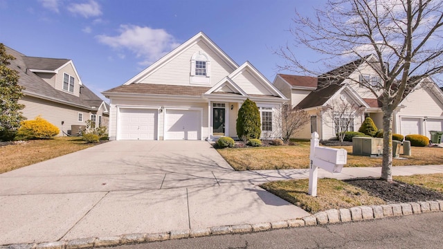 view of front of house with driveway, central air condition unit, and a garage