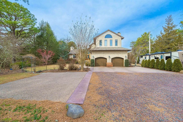 view of front of property with aphalt driveway, a chimney, and an attached garage