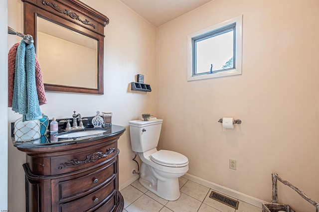 half bathroom featuring toilet, vanity, baseboards, visible vents, and tile patterned floors