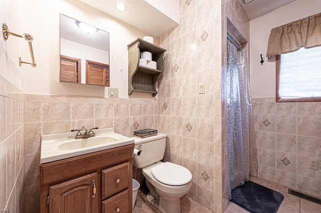 full bath featuring toilet, visible vents, vanity, tile walls, and a shower with curtain