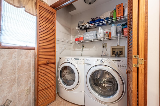 laundry room featuring light tile patterned floors, laundry area, and washer and dryer