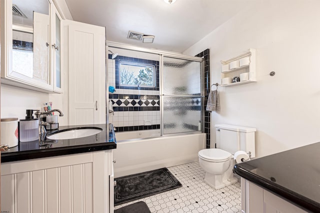 full bathroom featuring enclosed tub / shower combo, visible vents, vanity, and toilet