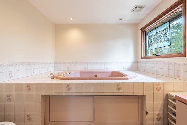 full bath with a tub with jets, visible vents, and recessed lighting