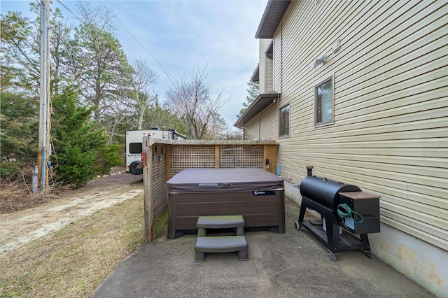 exterior space with a hot tub