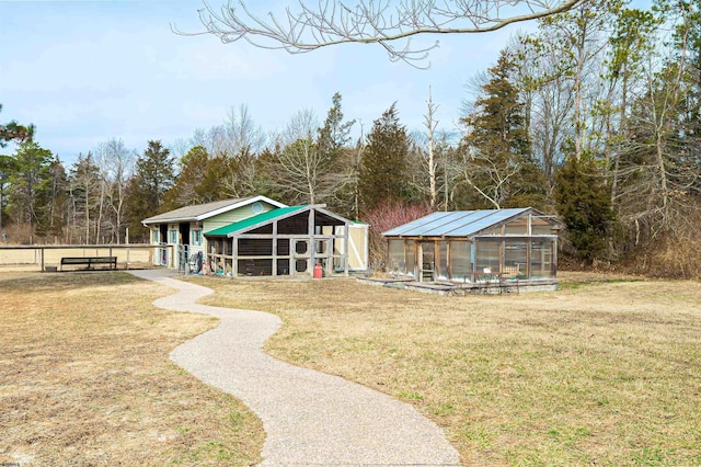 view of home's community featuring a yard, an outdoor structure, and an exterior structure