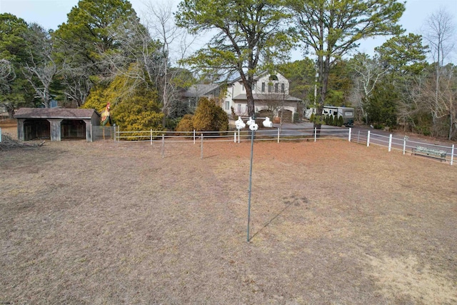 view of yard with an outdoor structure and fence