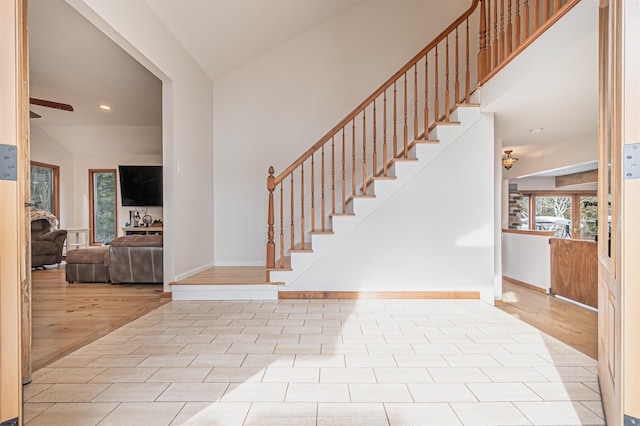 foyer entrance featuring stairway, wood finished floors, and baseboards