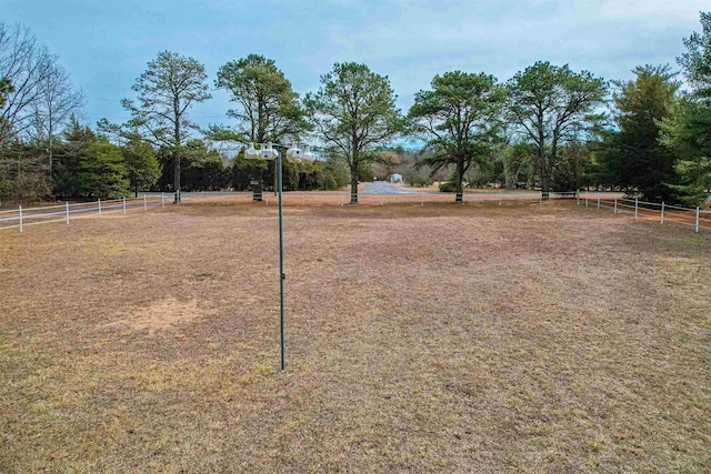 view of yard featuring community basketball court and fence