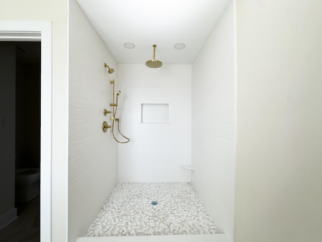 bathroom with tiled shower