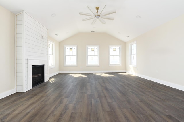 unfurnished living room featuring a large fireplace, baseboards, dark wood finished floors, and lofted ceiling