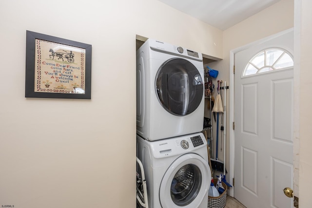 laundry area featuring stacked washing maching and dryer and laundry area