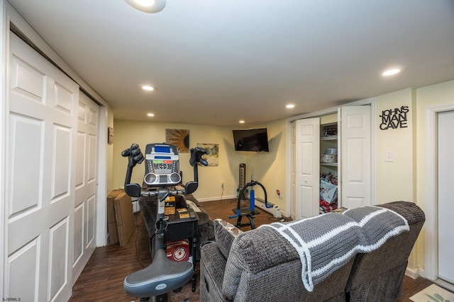 workout area featuring dark wood-type flooring, recessed lighting, and baseboards