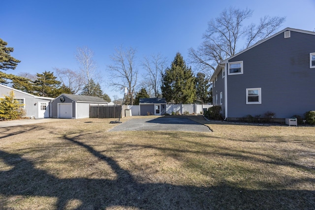 view of yard with an outdoor structure and fence