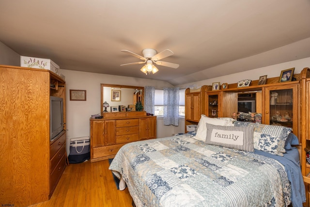 bedroom with light wood-style floors and a ceiling fan