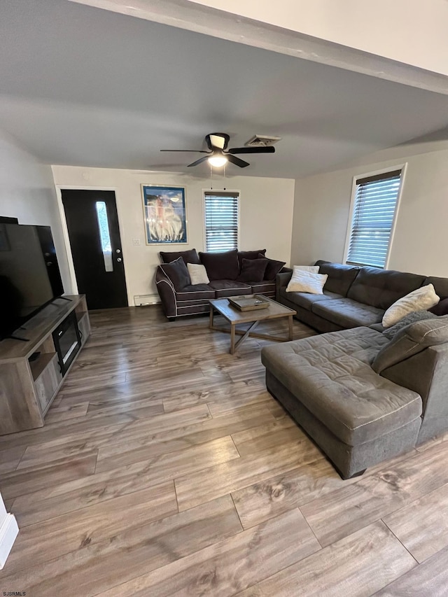 living room with ceiling fan and wood finished floors