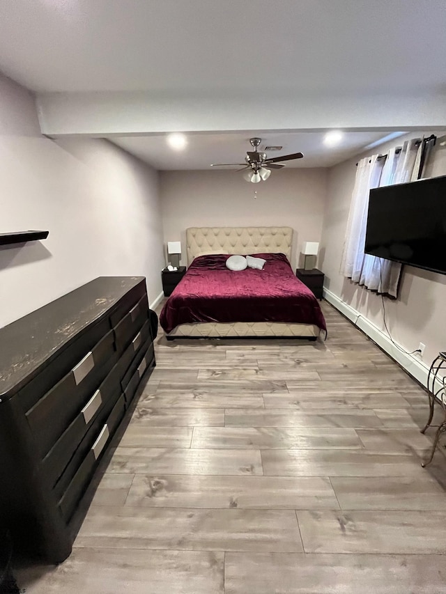 bedroom with ceiling fan, baseboards, and wood finished floors