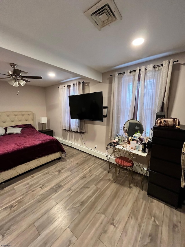 bedroom with recessed lighting, wood finished floors, visible vents, and baseboards