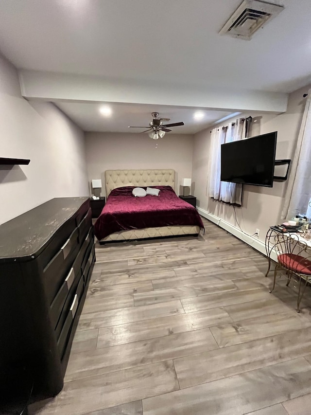 bedroom with visible vents, ceiling fan, light wood-style flooring, and baseboards