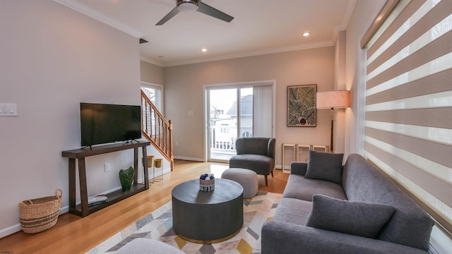 living room featuring recessed lighting, wood finished floors, baseboards, stairway, and crown molding