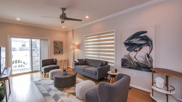 living area featuring baseboards, ceiling fan, ornamental molding, wood finished floors, and recessed lighting