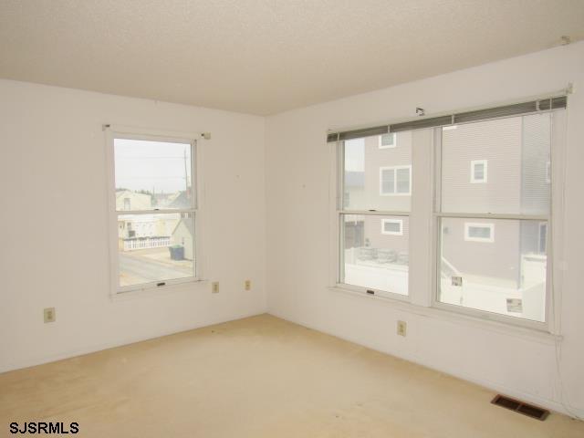 carpeted spare room with visible vents