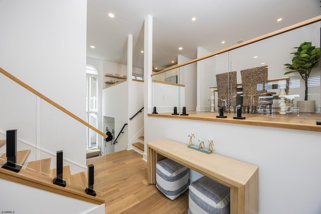 stairs featuring recessed lighting and wood finished floors