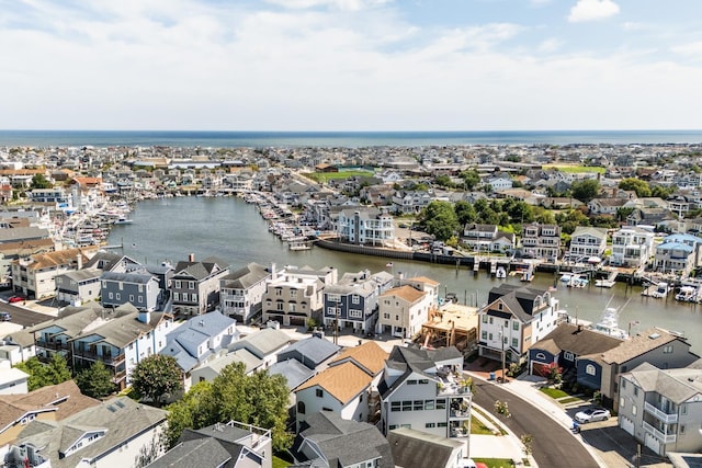 drone / aerial view featuring a residential view and a water view