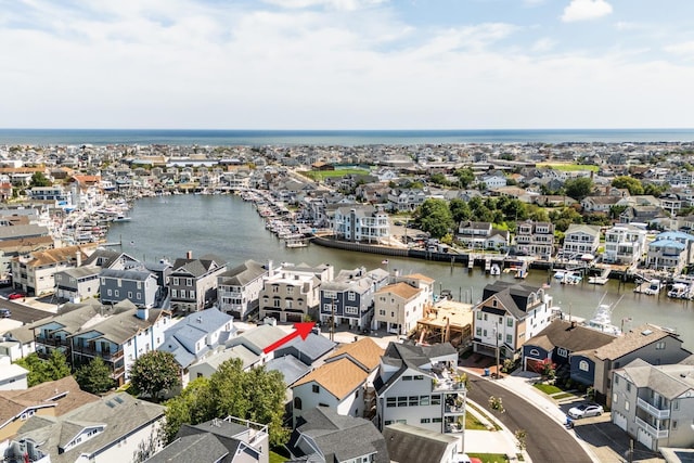 bird's eye view featuring a water view and a residential view