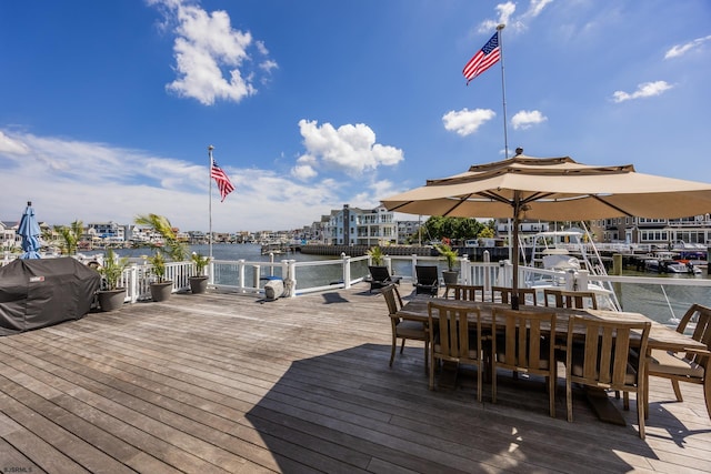 view of dock featuring a water view and outdoor dining area