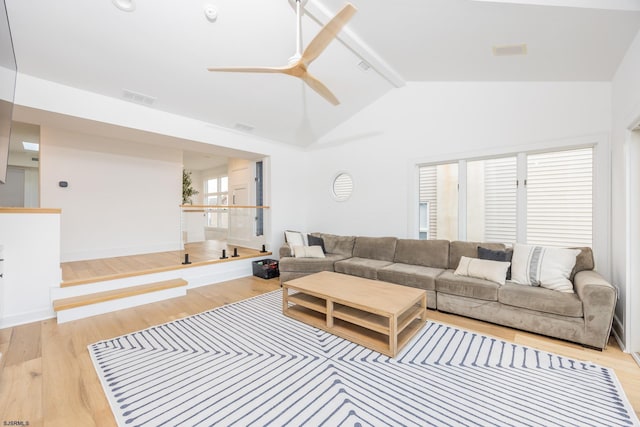 living area featuring visible vents, ceiling fan, and light wood finished floors