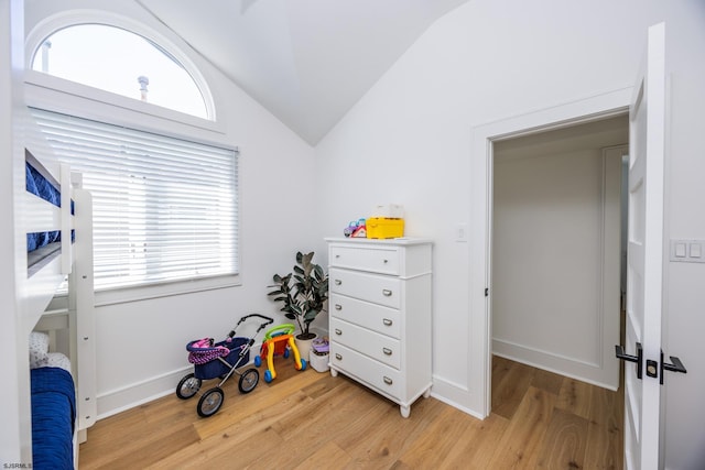 playroom with vaulted ceiling, light wood-style flooring, and baseboards