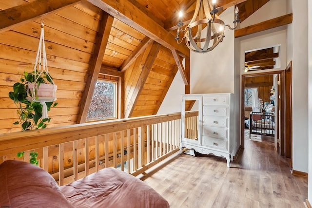 interior space with a chandelier, wooden ceiling, vaulted ceiling with beams, and wood finished floors