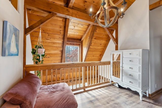 sitting room with wood ceiling, vaulted ceiling with beams, an inviting chandelier, and wood finished floors