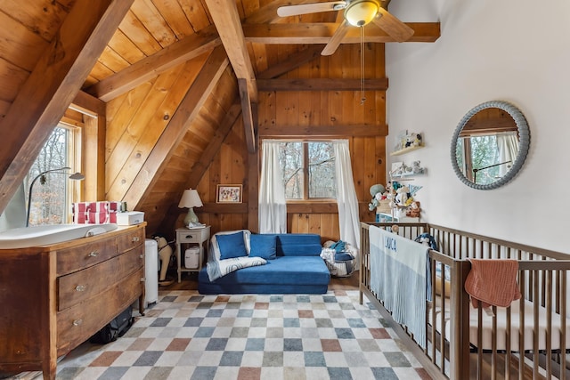 interior space with lofted ceiling with beams, wood ceiling, and wooden walls