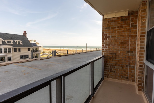 balcony with a beach view and a water view