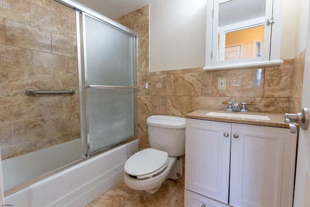 full bathroom with toilet, shower / bath combination with glass door, tile walls, and vanity