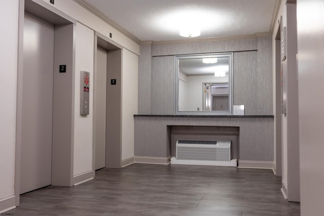 hall with crown molding, an AC wall unit, a textured ceiling, and elevator