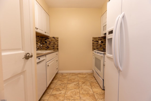 kitchen with decorative backsplash, white cabinets, a sink, white appliances, and baseboards