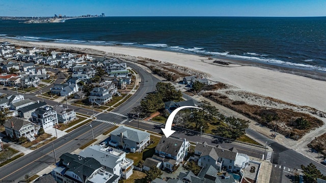 aerial view featuring a residential view, a water view, and a beach view