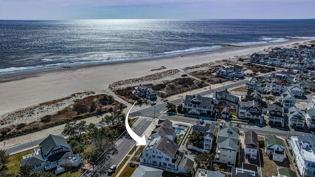 bird's eye view featuring a water view and a view of the beach