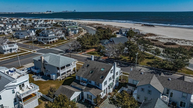 aerial view with a water view, a residential view, and a view of the beach